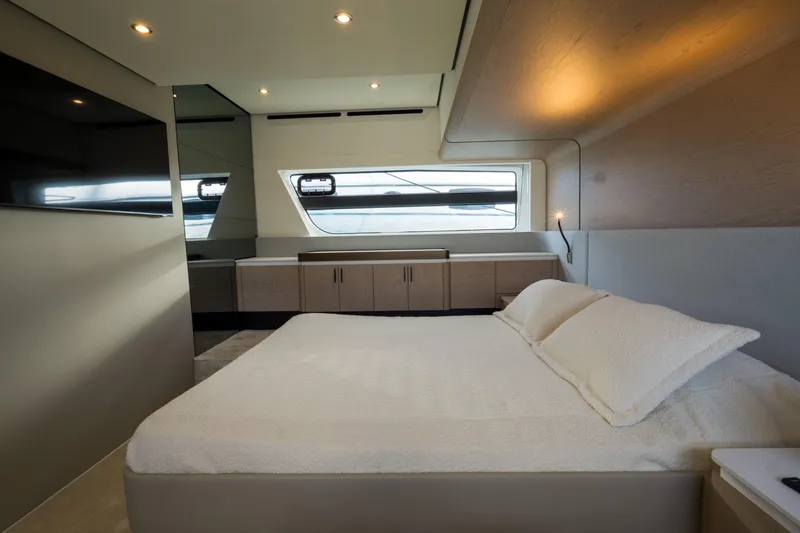  Yacht Photos Pics Luxurious bedroom interior of 2022 Azimut Fly 53 yacht with modern design and large window.