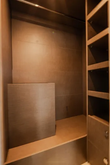  Yacht Photos Pics Interior storage space on 2022 Azimut Fly 53 yacht, featuring wooden shelves and paneling.