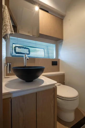 Yacht Photos Pics Modern bathroom in 2022 Azimut Fly 53 yacht with sleek fixtures and wooden cabinetry.