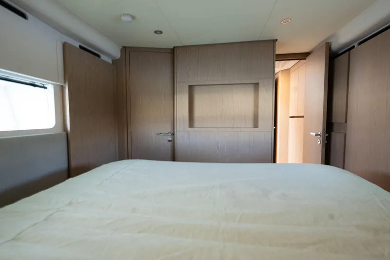  Yacht Photos Pics Interior cabin of 2022 Azimut Fly 53 yacht, featuring modern wood paneling and a cozy bed.