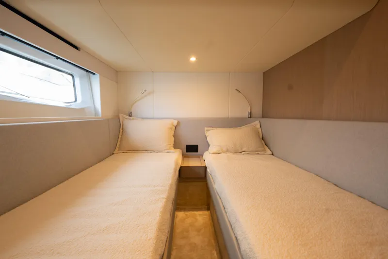  Yacht Photos Pics Twin cabin interior of 2022 Azimut Fly 53 yacht, featuring modern design and cozy bedding.