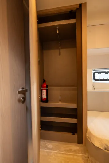  Yacht Photos Pics Interior of 2022 Azimut Fly 53 yacht with open closet and fire extinguisher.