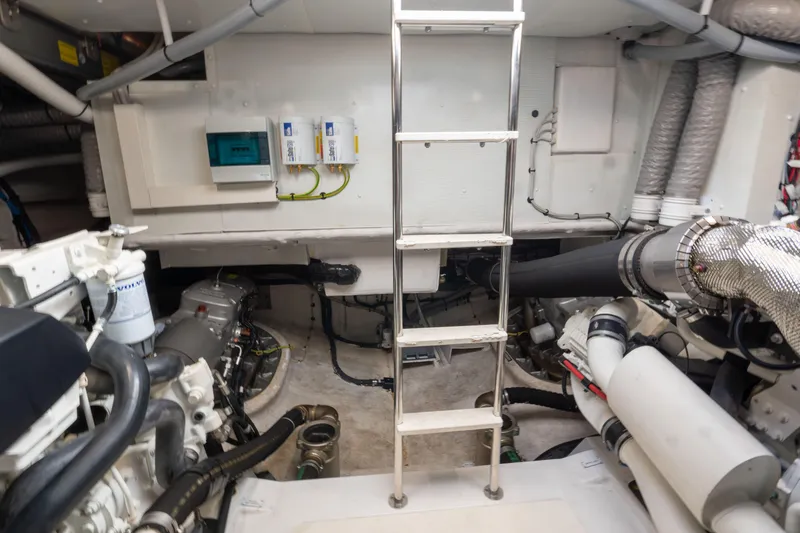  Yacht Photos Pics Engine room of 2022 Azimut Fly 53 yacht, featuring mechanical components and ladder.