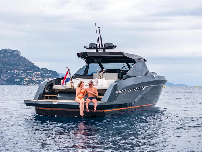  Yacht Photos Pics 2023 Bekkers Yachts Azur 45HT cruising with two people on deck, scenic coastal backdrop.