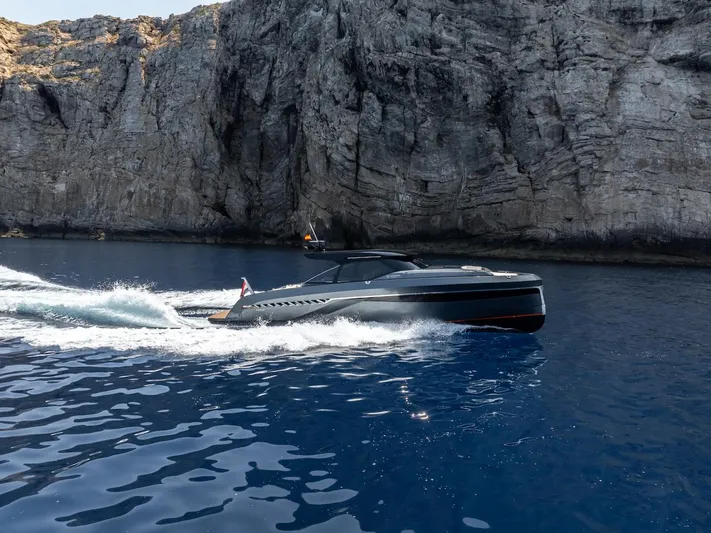  Yacht Photos Pics 2023 Bekkers Yachts Azur 45HT cruising near rocky cliffs on a clear blue sea.
