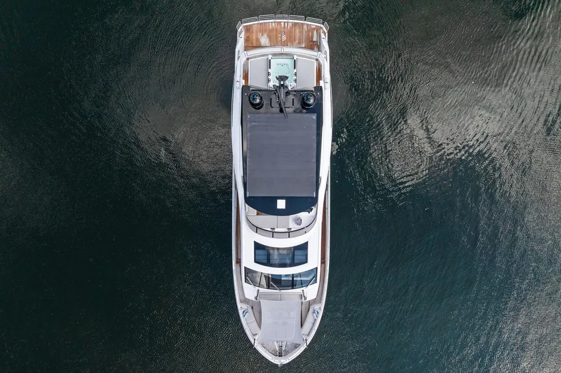 Don Tortuga Yacht Photos Pics Aerial view of 2024 Sunseeker 90 Ocean yacht on calm water.