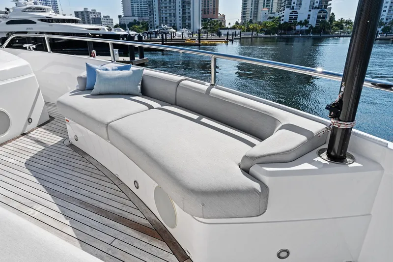 Don Tortuga Yacht Photos Pics Luxurious seating area on 2024 Sunseeker 90 Ocean yacht, docked in a marina.