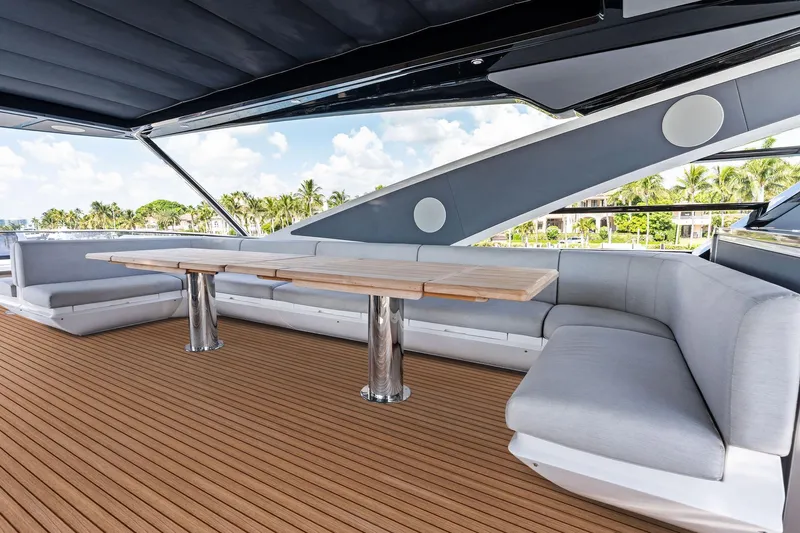 Don Tortuga Yacht Photos Pics Luxurious outdoor seating on 2024 Sunseeker 90 Ocean yacht with sleek design and wooden deck.