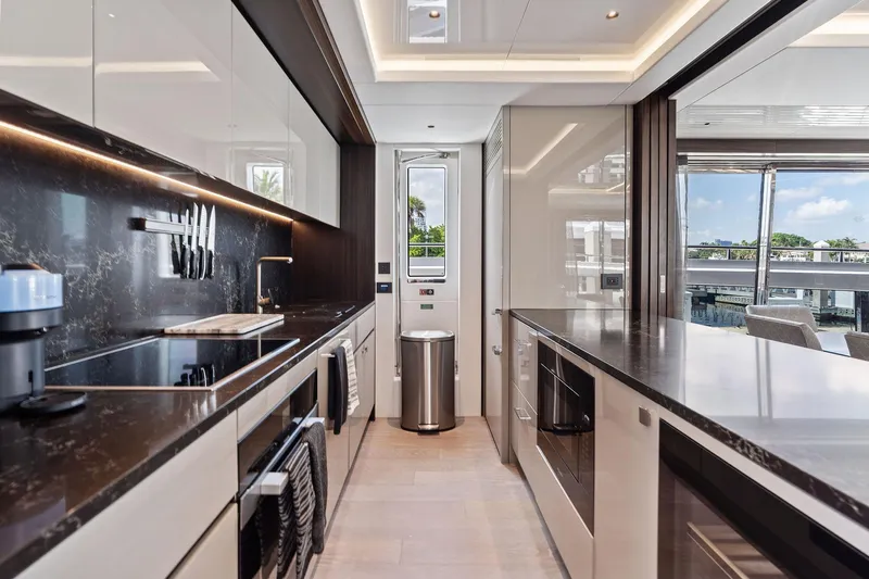 Don Tortuga Yacht Photos Pics Luxurious kitchen interior of 2024 Sunseeker 90 Ocean yacht with modern appliances and sleek design.