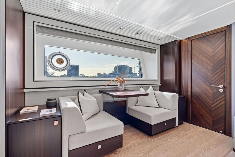 Don Tortuga Yacht Photos Pics Luxurious interior of 2024 Sunseeker 90 Ocean yacht with elegant seating and large window view.