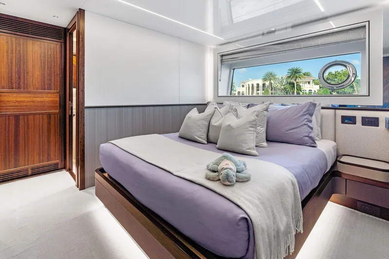 Don Tortuga Yacht Photos Pics Luxurious bedroom interior of 2024 Sunseeker 90 Ocean yacht with elegant decor and scenic window view.