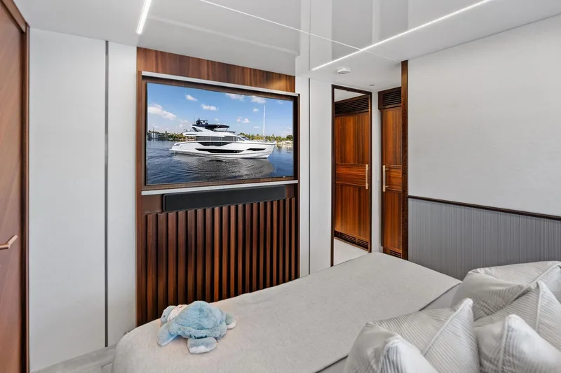 Don Tortuga Yacht Photos Pics Luxurious 2024 Sunseeker 90 Ocean yacht interior with elegant wood finishes and plush bedding.
