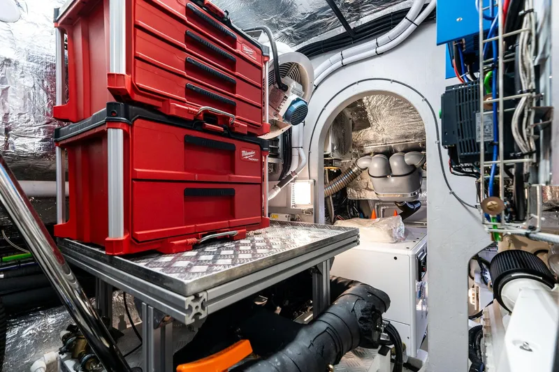 Don Tortuga Yacht Photos Pics Engine room of 2024 Sunseeker 90 Ocean yacht with red toolboxes and machinery.