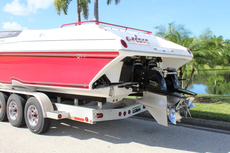Lightning Yacht Photos Pics 2007 Fountain 42 Lightning boat on trailer, red and white, parked near palm trees.