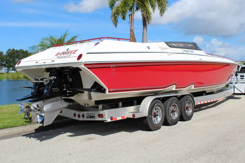 Lightning Yacht Photos Pics Red and white 2007 Fountain 42 Lightning speedboat on a trailer by a lake.