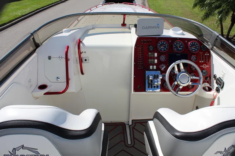 Lightning Yacht Photos Pics 2007 Fountain 42 Lightning boat cockpit with Garmin navigation system and red accents.