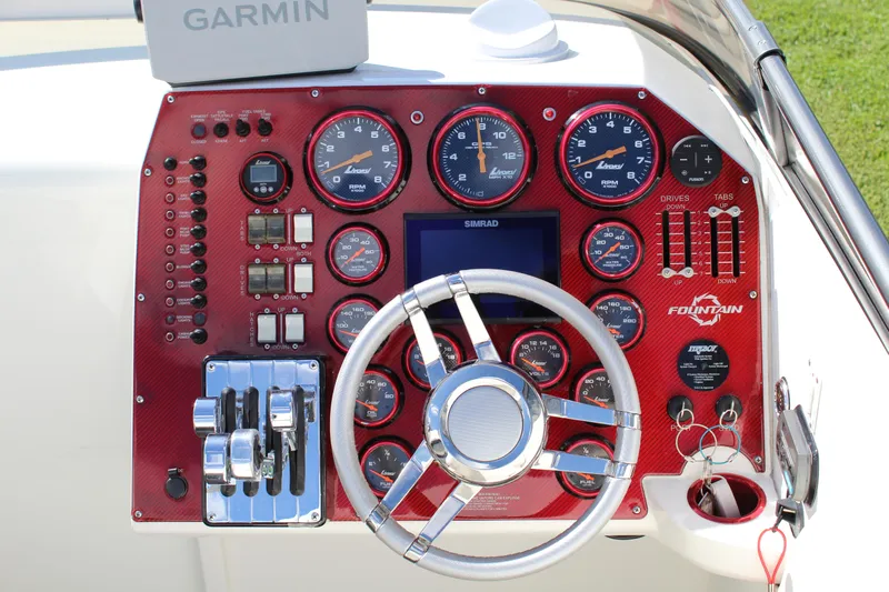 Lightning Yacht Photos Pics Dashboard of a 2007 Fountain 42 Lightning boat with steering wheel and gauges.