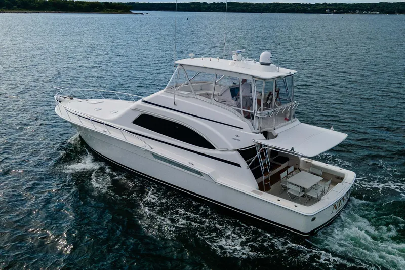 Nine Yacht Photos Pics 2008 Bertram 570 yacht cruising on open water, showcasing sleek design and spacious deck.