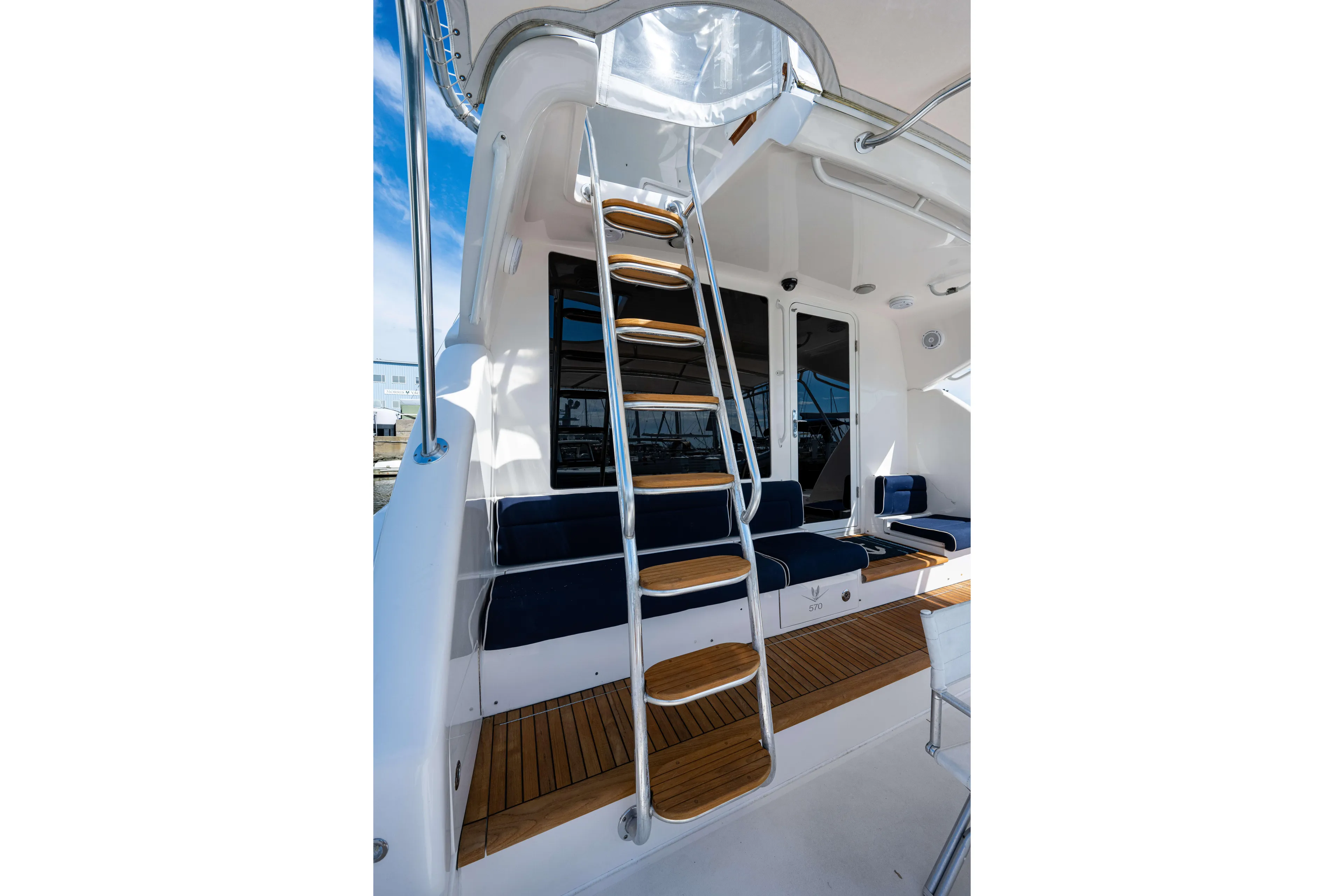 Nine Yacht Photos Pics 2008 Bertram 570 yacht interior with wooden steps and seating area.