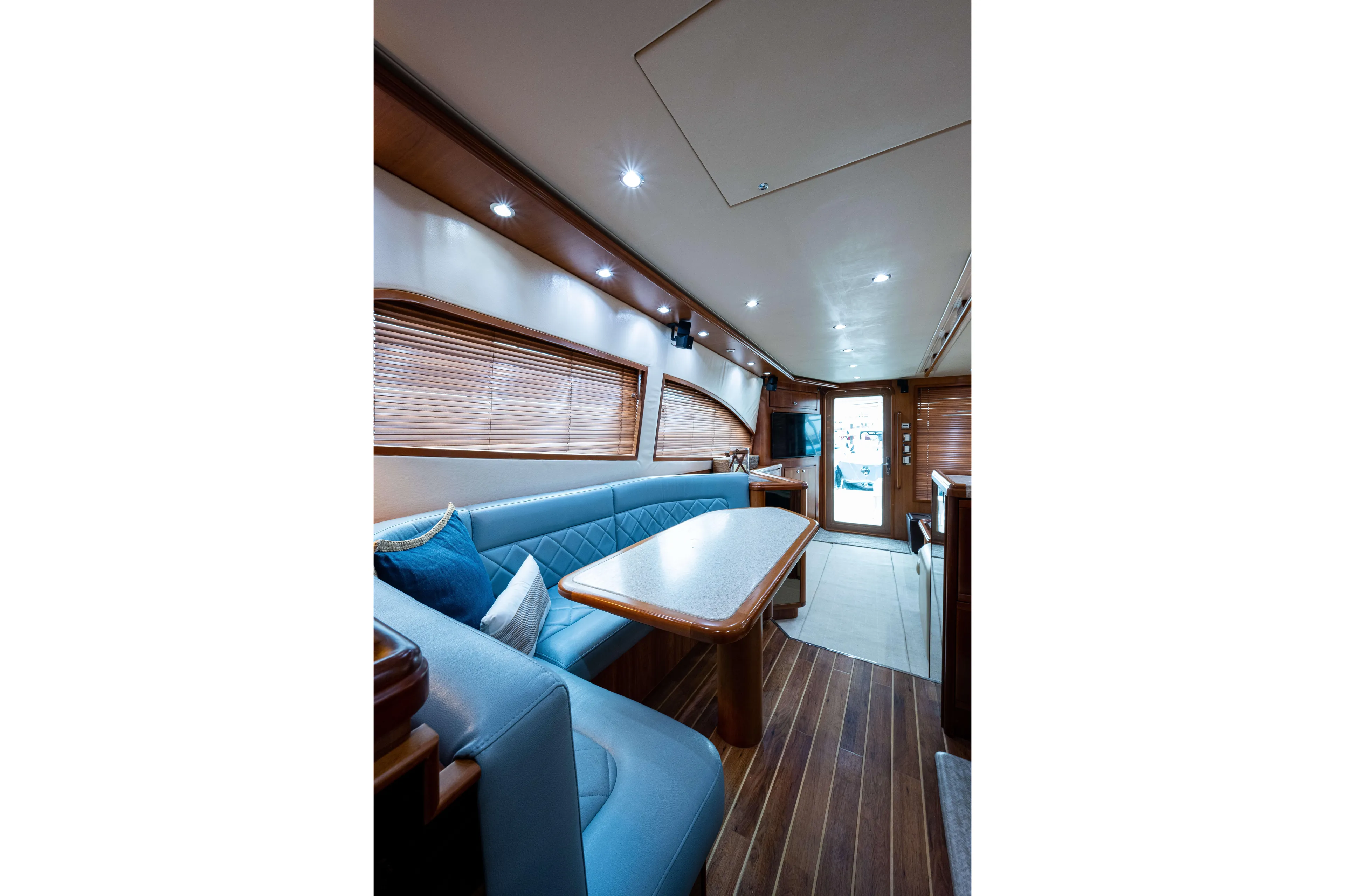 Nine Yacht Photos Pics Luxurious interior of 2008 Bertram 570 yacht with elegant seating and wooden accents.