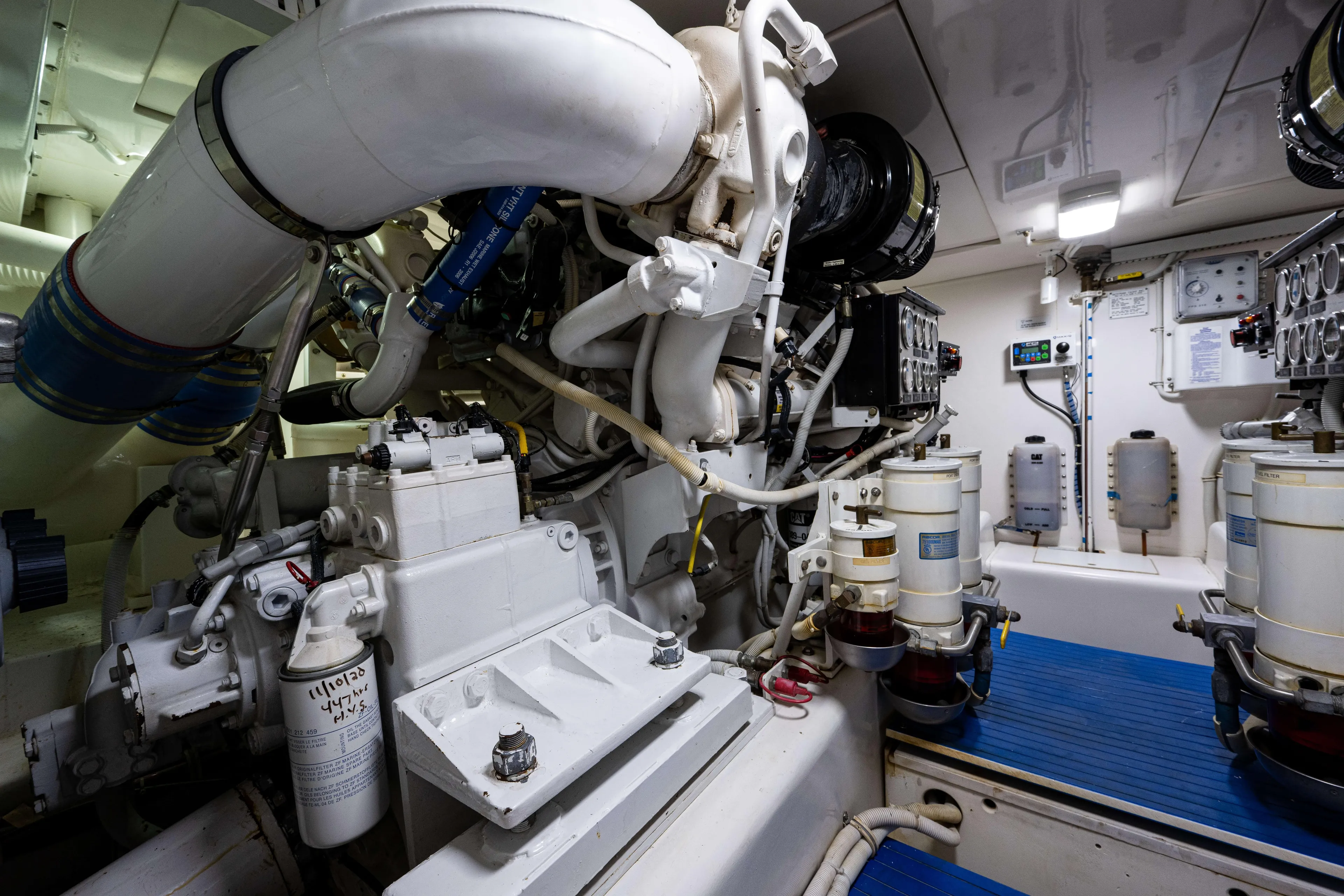 Nine Yacht Photos Pics Engine room of a 2008 Bertram 570 yacht, showcasing complex machinery and components.