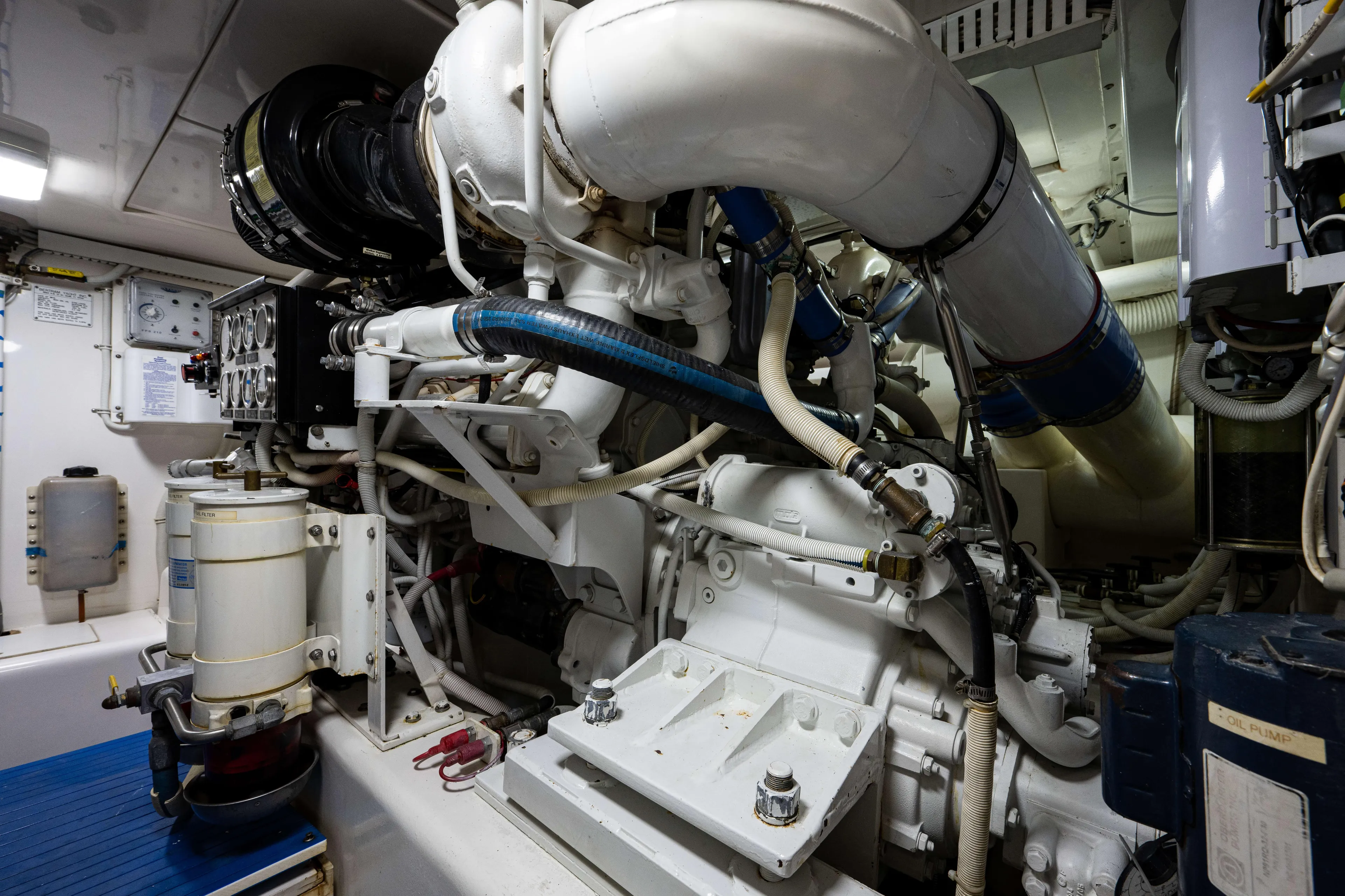 Nine Yacht Photos Pics Engine room of a 2008 Bertram 570 yacht, showcasing complex machinery and piping.