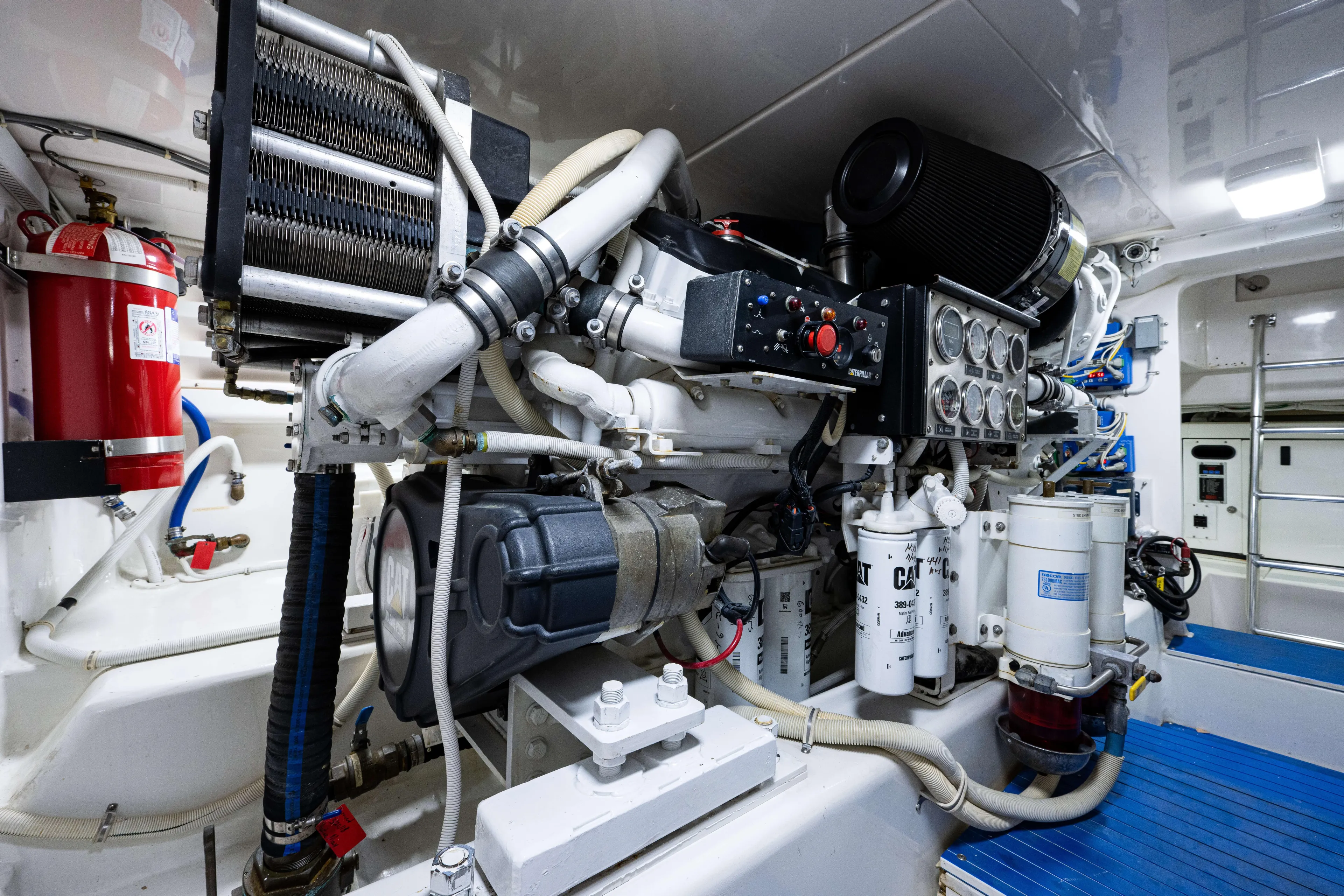 Nine Yacht Photos Pics Engine room of a 2008 Bertram 570 yacht, featuring mechanical components and fire extinguisher.