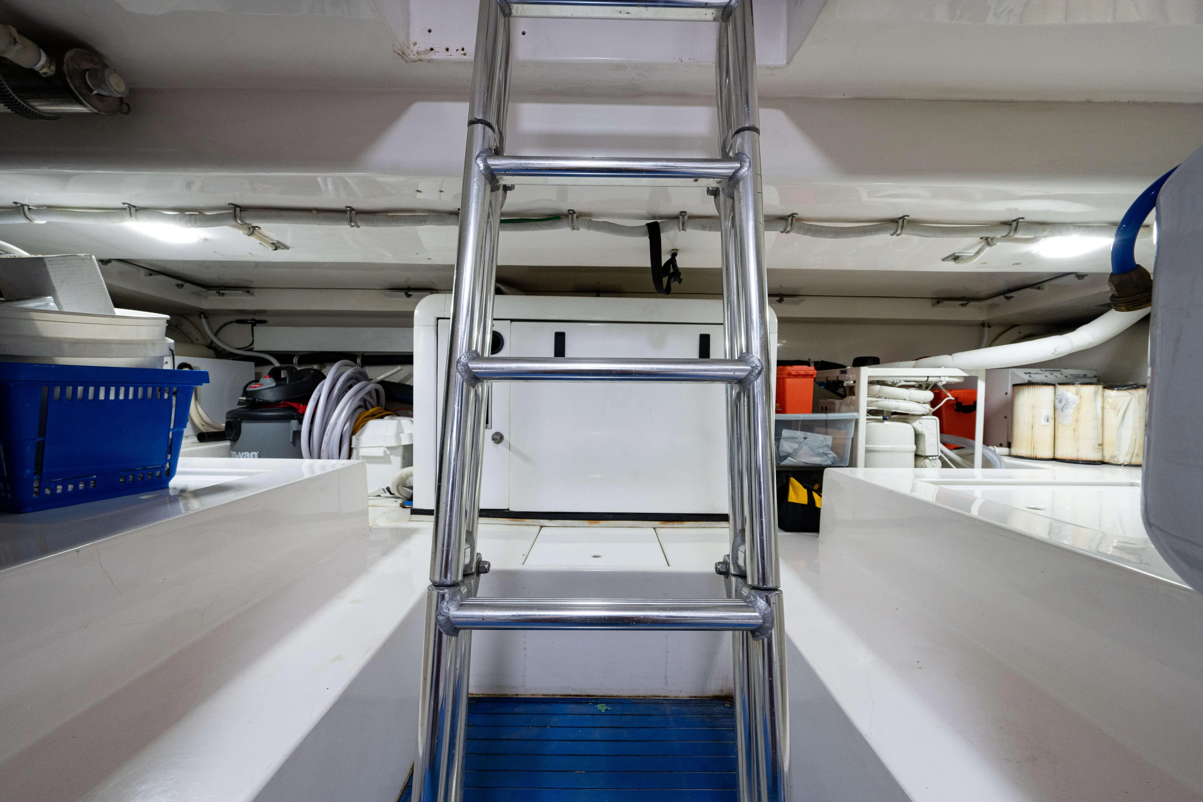 Nine Yacht Photos Pics Engine room of 2008 Bertram 570 yacht with metal ladder and equipment.