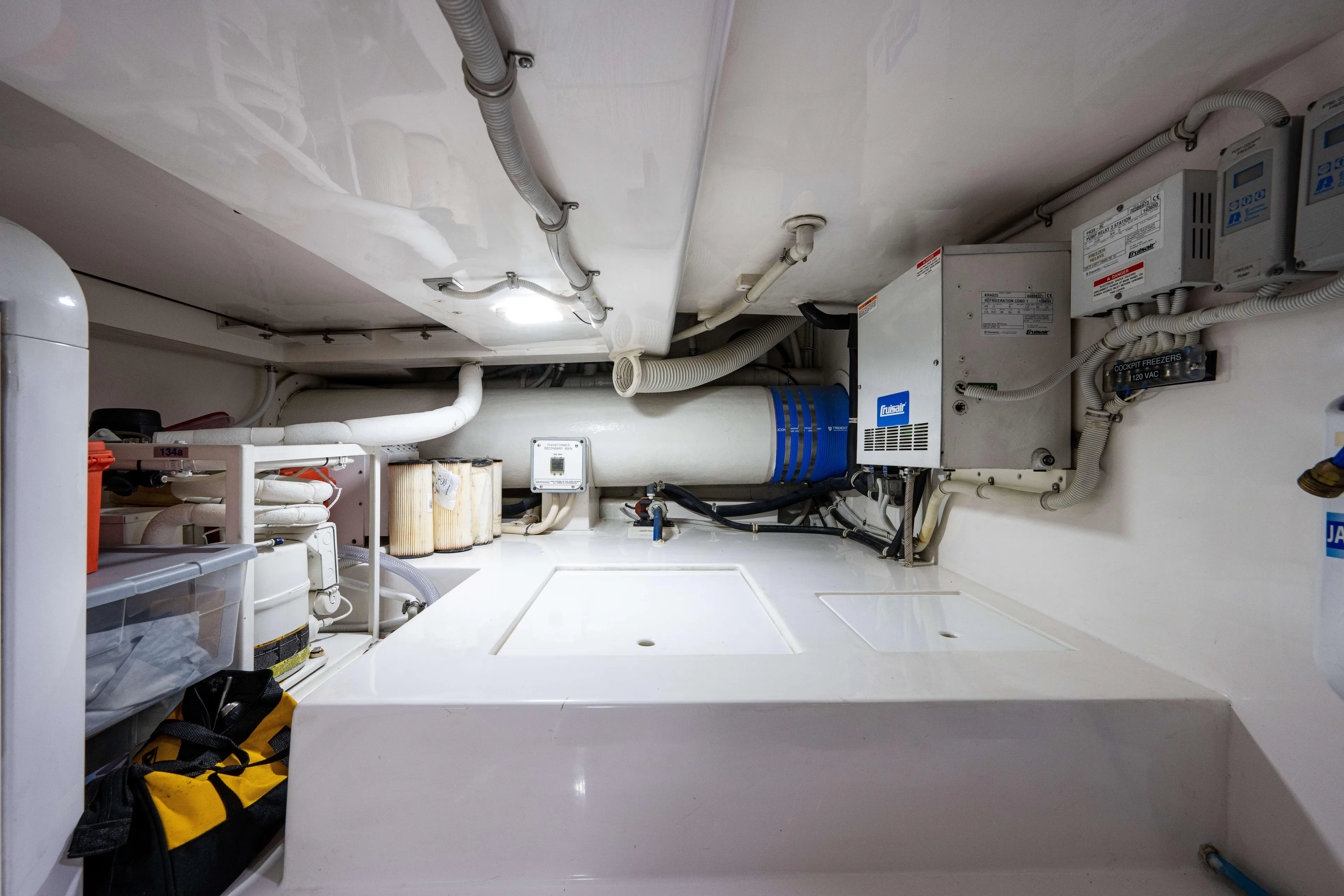 Nine Yacht Photos Pics Engine room of a 2008 Bertram 570 yacht, featuring various mechanical components and storage.