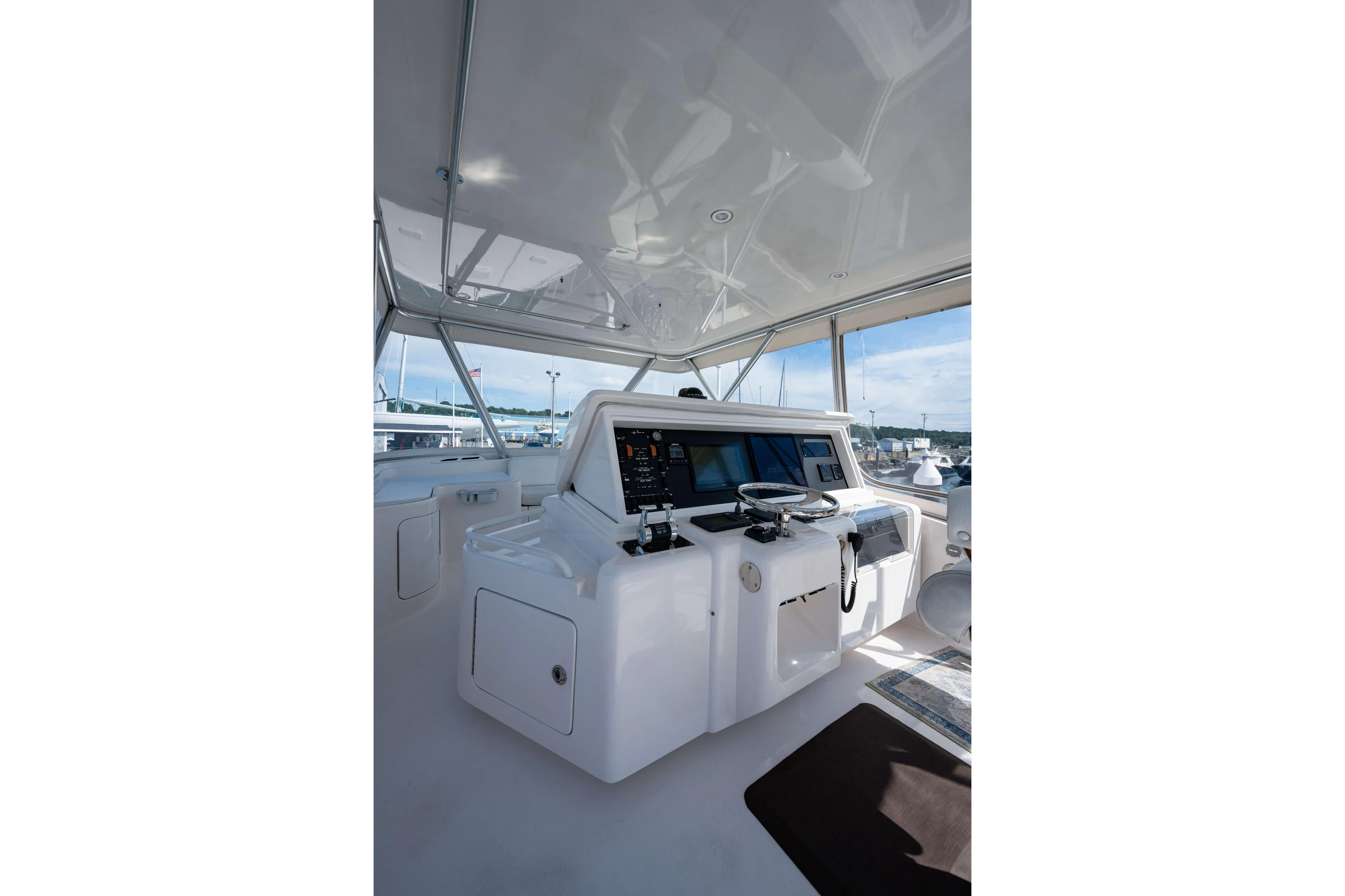 Nine Yacht Photos Pics 2008 Bertram 570 yacht helm station with modern navigation equipment and panoramic views.