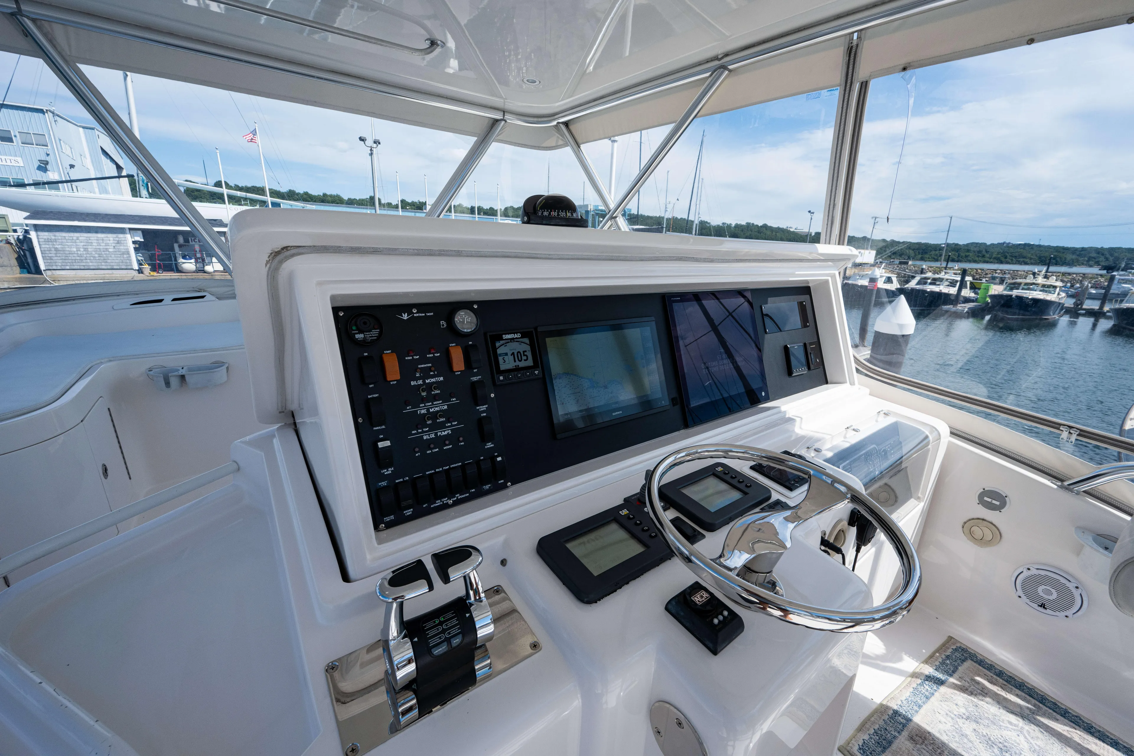 Nine Yacht Photos Pics 2008 Bertram 570 yacht helm with advanced navigation controls and marina view.
