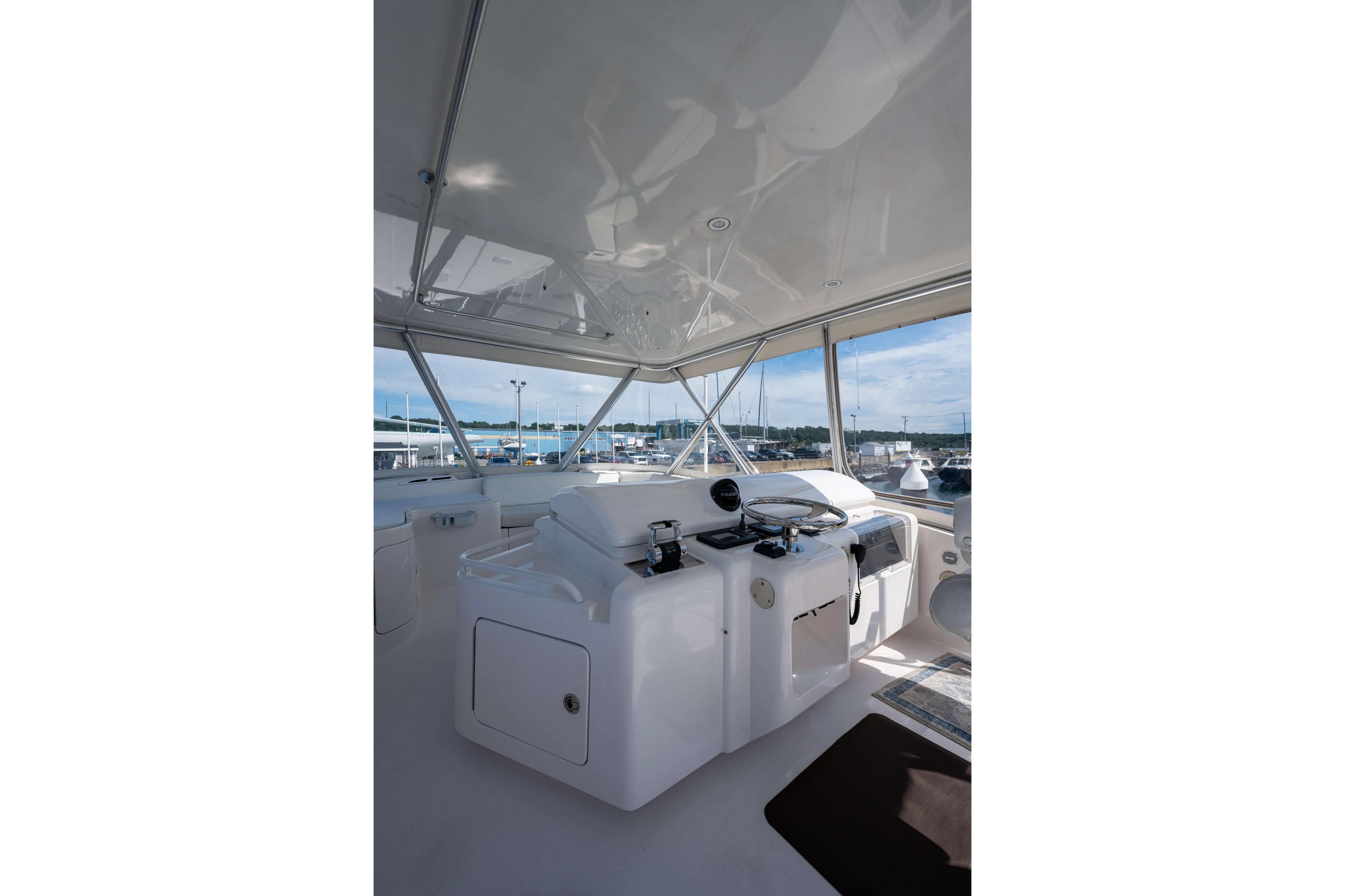 Nine Yacht Photos Pics Interior view of 2008 Bertram 570 yacht helm with panoramic marina view.