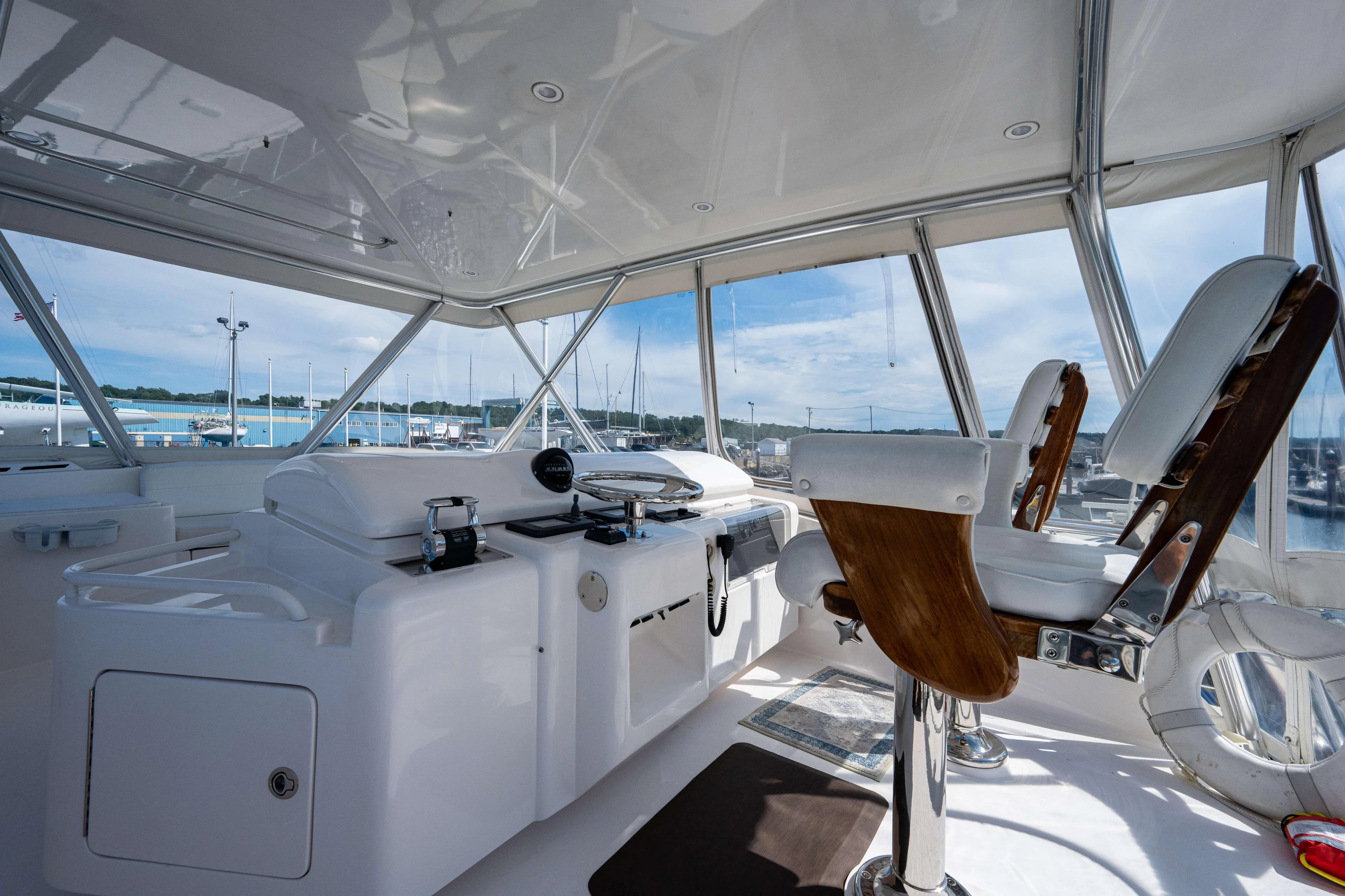 Nine Yacht Photos Pics Interior view of 2008 Bertram 570 yacht cockpit with steering and seating.