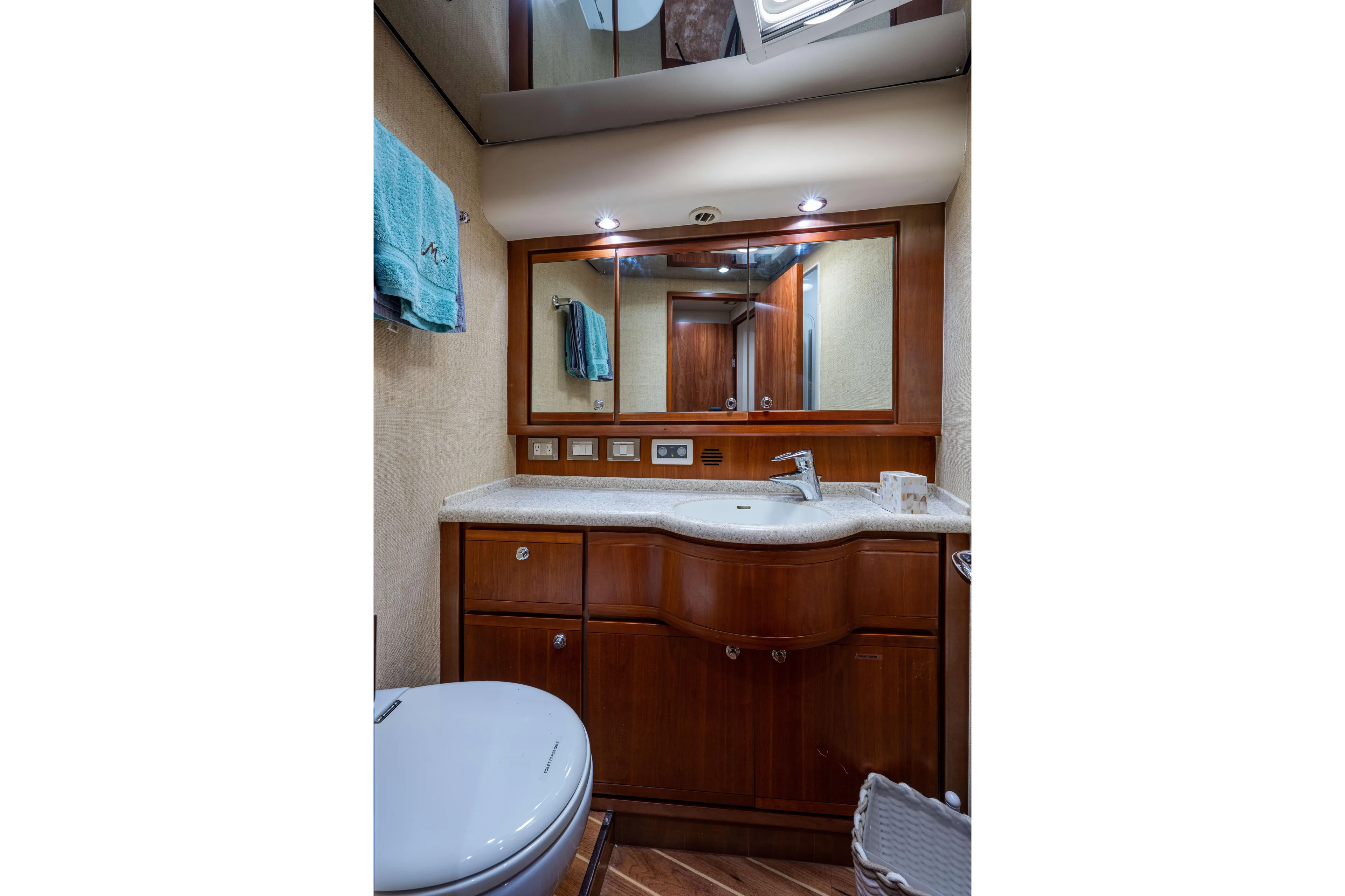 Nine Yacht Photos Pics Luxurious bathroom in a 2008 Bertram 570 yacht with wooden cabinetry and modern fixtures.