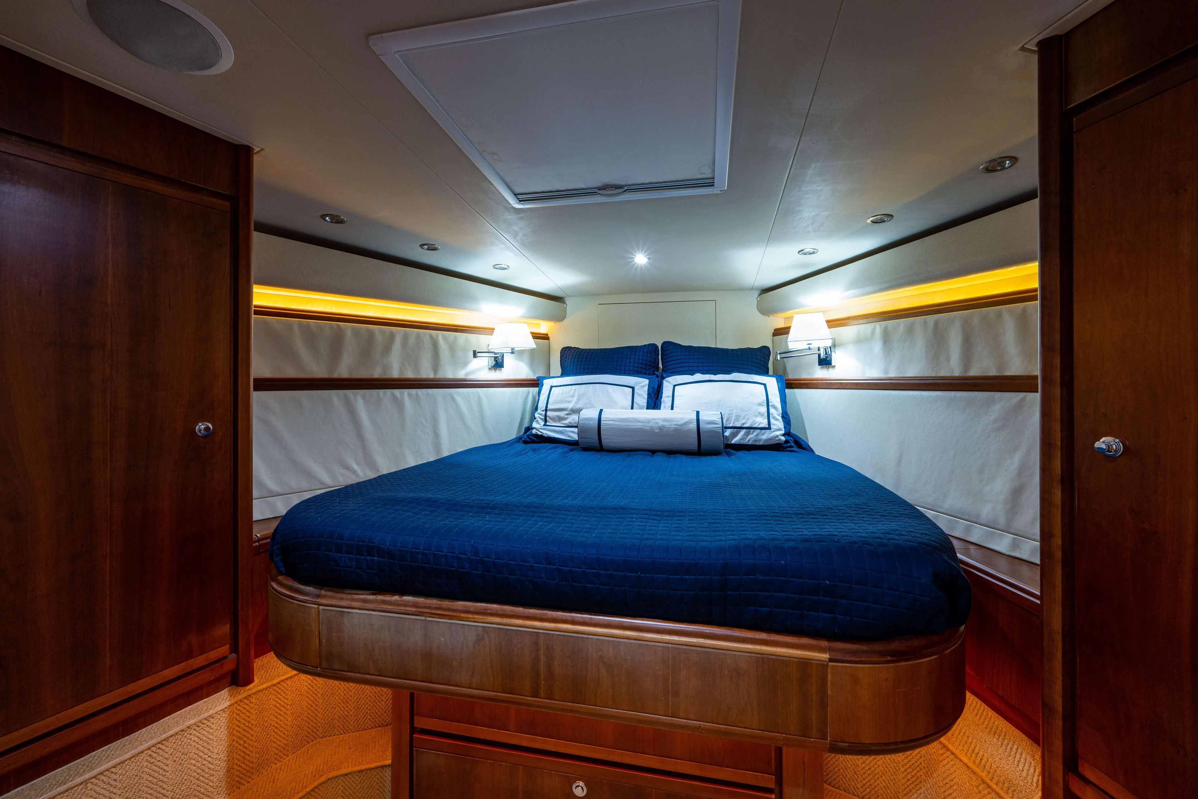 Nine Yacht Photos Pics Luxurious cabin interior of 2008 Bertram 570 yacht with elegant bedding and warm lighting.