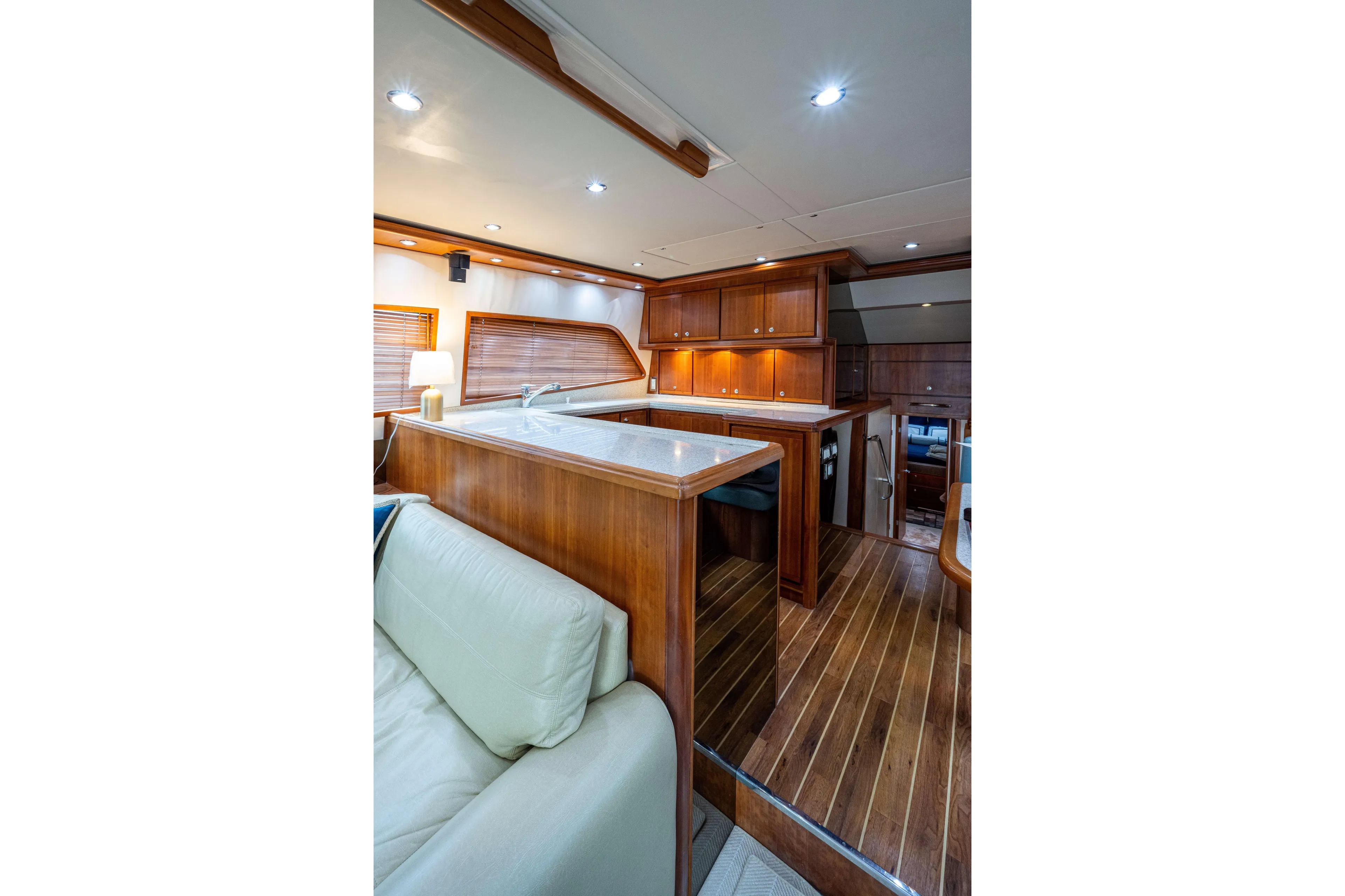 Nine Yacht Photos Pics Luxurious interior of 2008 Bertram 570 yacht with wooden cabinetry and modern lighting.