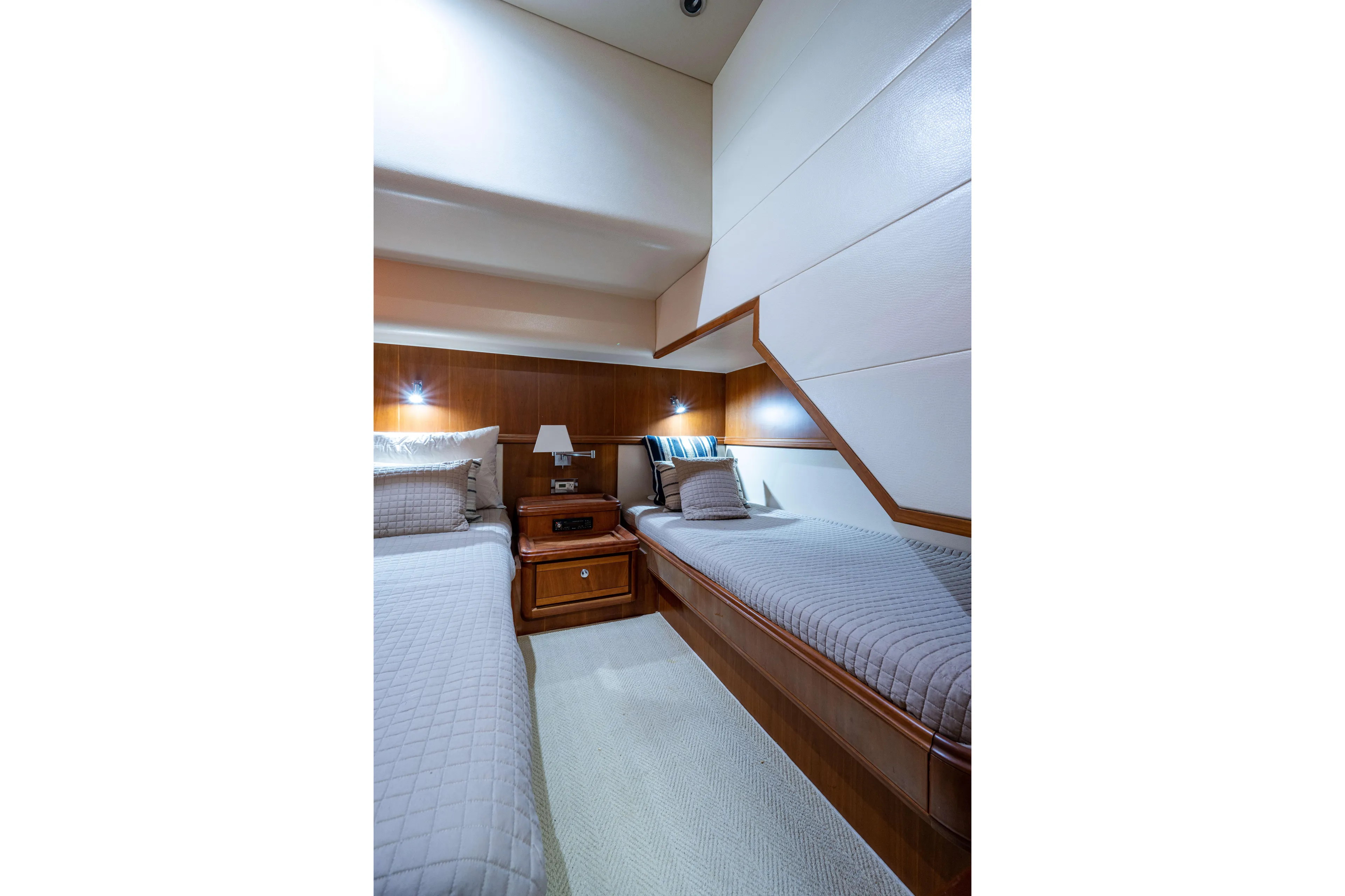 Nine Yacht Photos Pics Luxurious 2008 Bertram 570 yacht cabin with twin beds and elegant wood paneling.