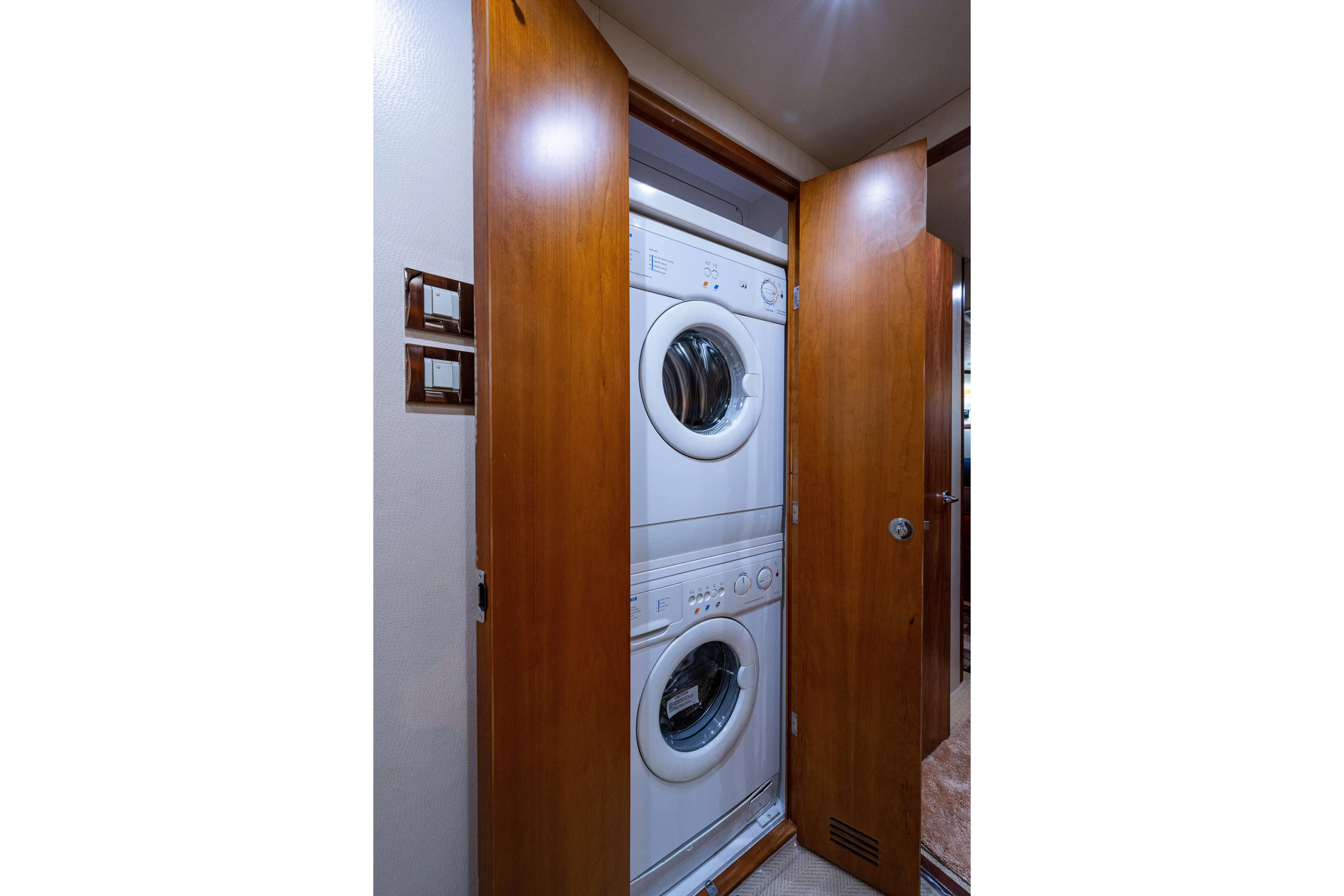 Nine Yacht Photos Pics Stacked washer and dryer in 2008 Bertram 570 yacht's wooden closet.