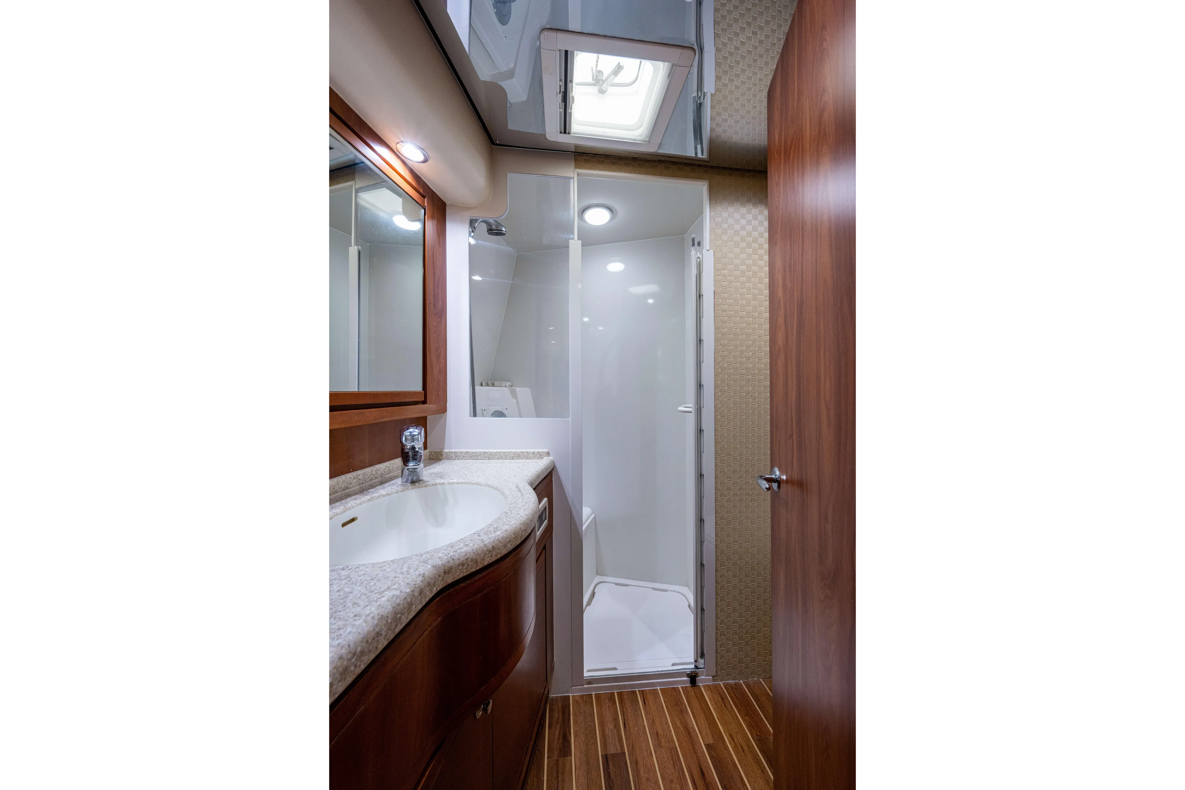 Nine Yacht Photos Pics Luxurious bathroom in 2008 Bertram 570 yacht with modern fixtures and wooden accents.