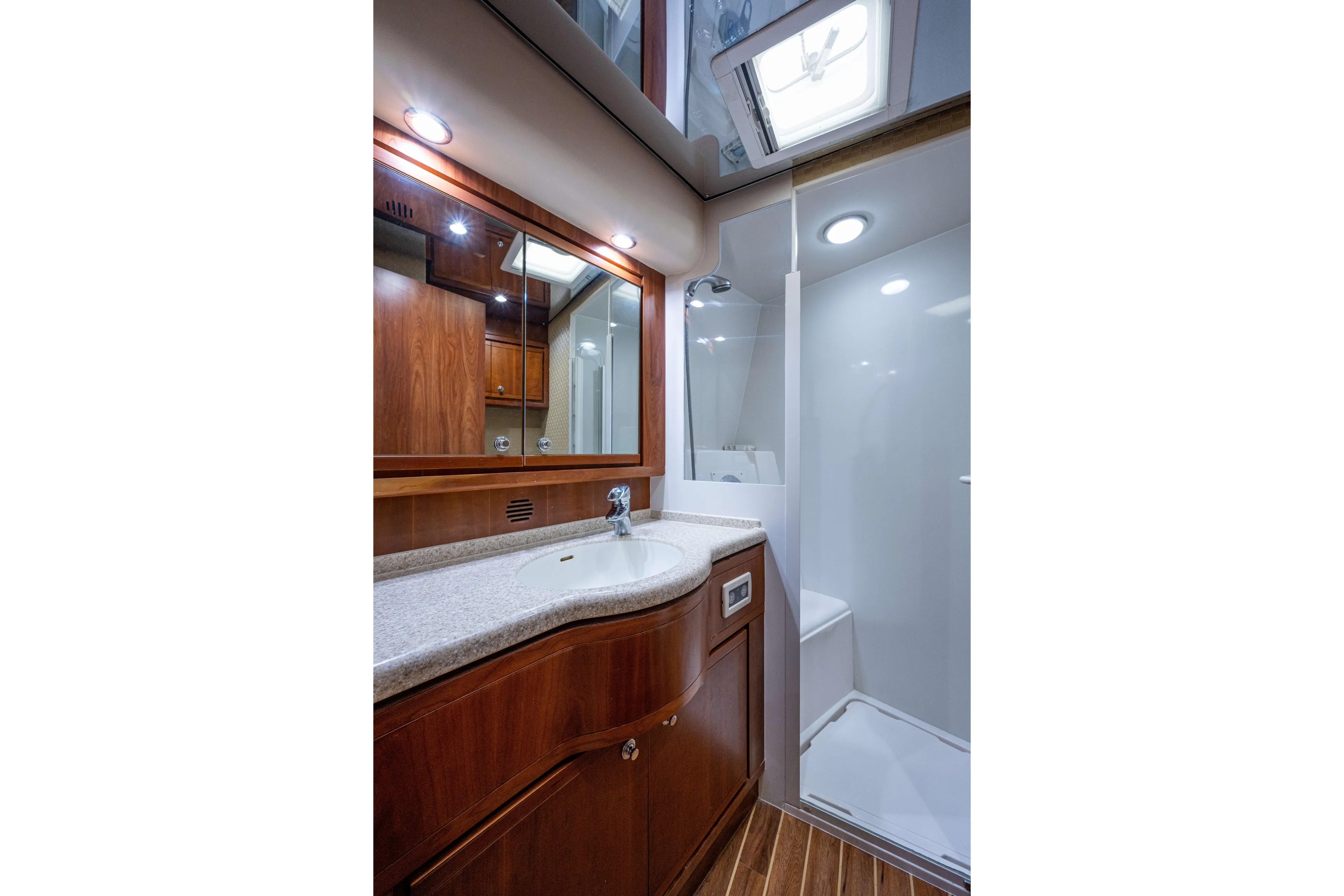Nine Yacht Photos Pics Luxurious bathroom in 2008 Bertram 570 yacht with wooden cabinetry and modern fixtures.