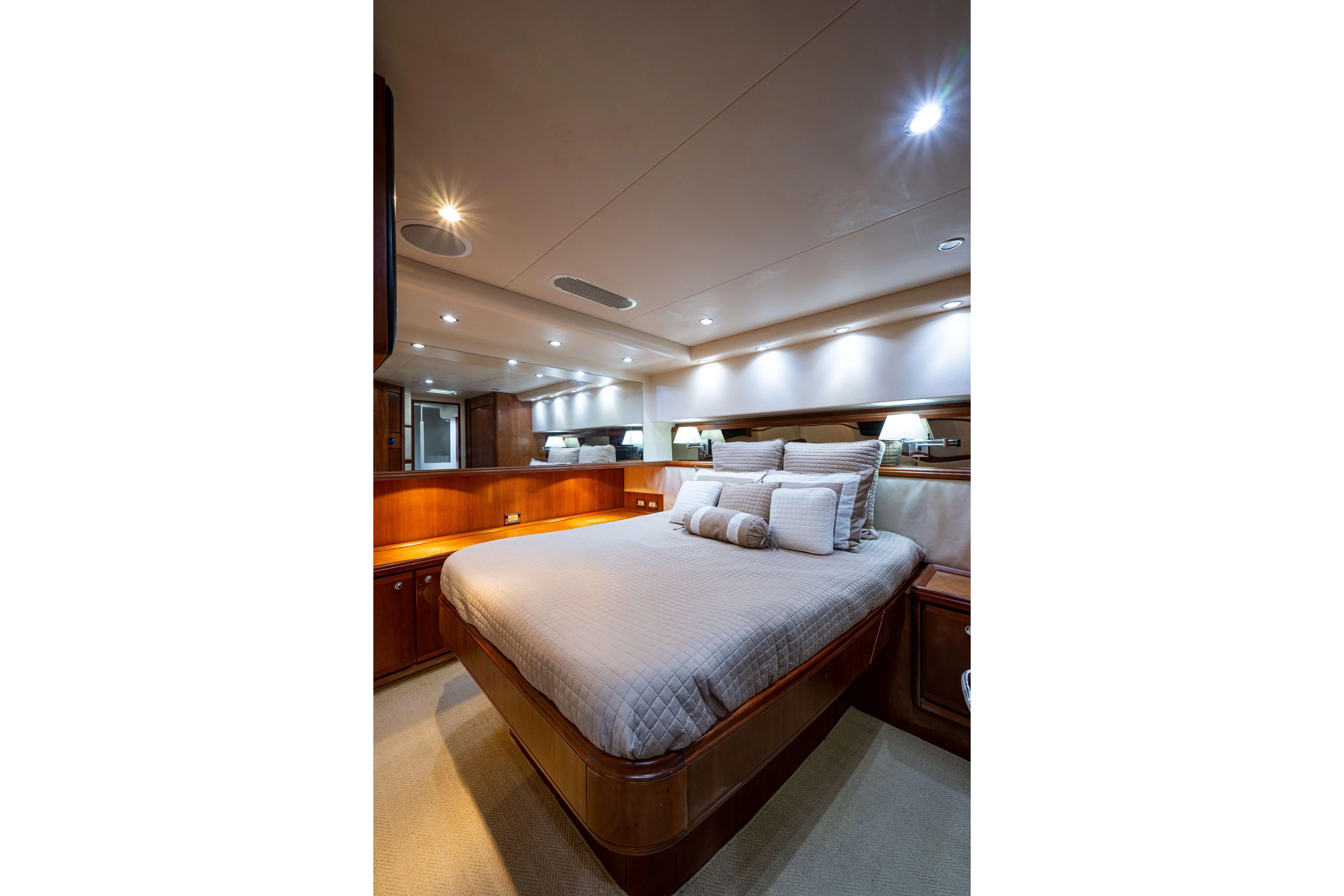 Nine Yacht Photos Pics Luxurious bedroom interior of 2008 Bertram 570 yacht with elegant lighting and plush bedding.