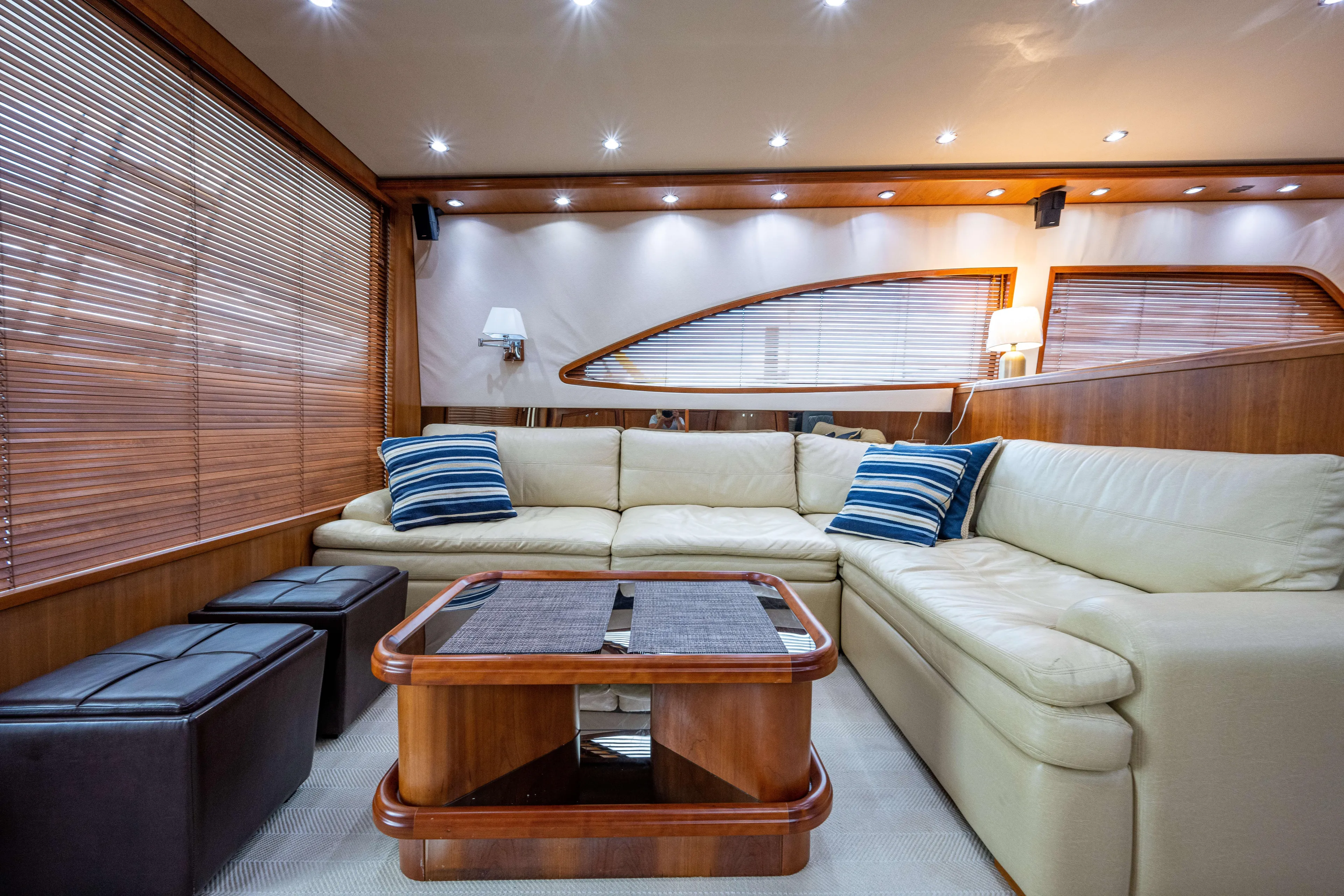 Nine Yacht Photos Pics Luxurious interior of 2008 Bertram 570 yacht with cream sofa and wooden accents.