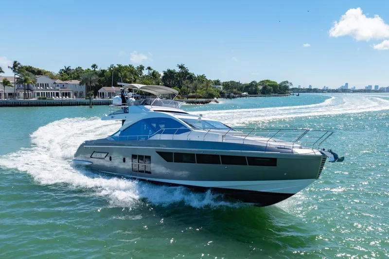 Azimut S7 Yacht Photos Pics Luxurious 2019 Azimut S7 yacht cruising on a sunny day near waterfront homes.
