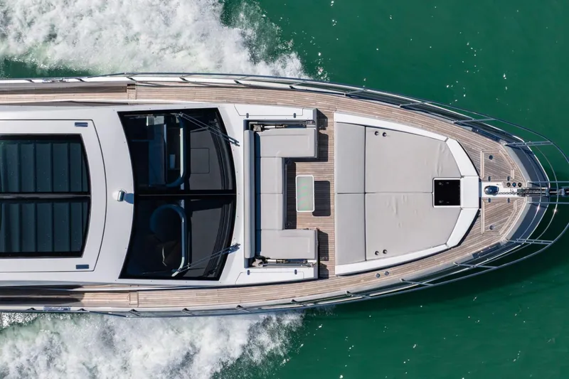 Azimut S7 Yacht Photos Pics Aerial view of 2019 Azimut S7 yacht cruising on turquoise water.