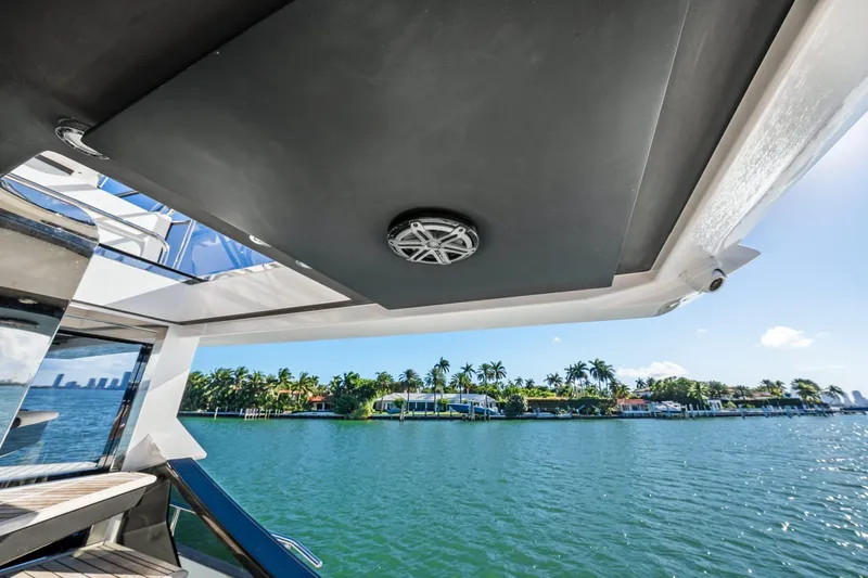 Azimut S7 Yacht Photos Pics 2019 Azimut S7 yacht view with tropical waterfront and palm trees in the background.