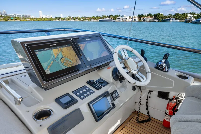 Azimut S7 Yacht Photos Pics Cockpit of 2019 Azimut S7 yacht with navigation screens and steering wheel.