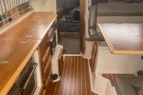  Yacht Photos Pics Interior of a 2020 Cutwater C-32 C boat with wood finishes and seating area.
