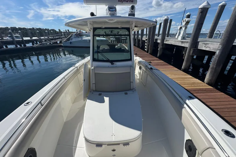  Yacht Photos Pics 2019 Boston Whaler 330 Outrage boat docked at marina under clear sky.