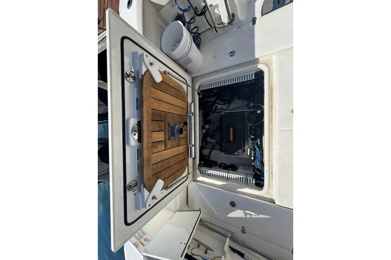  Yacht Photos Pics 2019 Boston Whaler 330 Outrage engine compartment with open hatch and visible equipment.