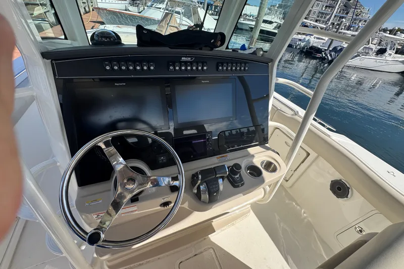  Yacht Photos Pics 2019 Boston Whaler 330 Outrage helm with steering wheel and navigation screens.